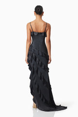 model wearing Kyla Asymmetrical Maxi Dress In Black back shot