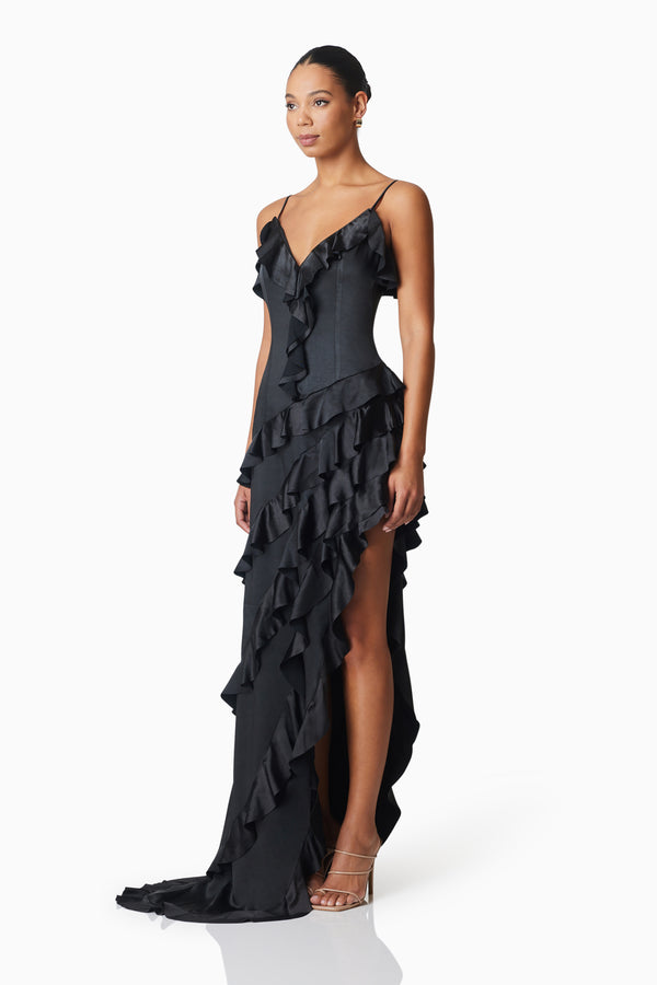 model wearing Kyla Asymmetrical Maxi Dress In Black side shot