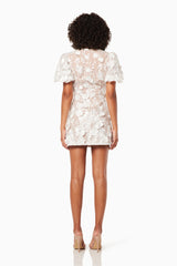 model wearing Zayla 3D floral mini dress in white back shot