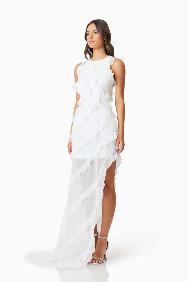 Brunette model wearing Celeana Textured Sheer Dress in White side shot