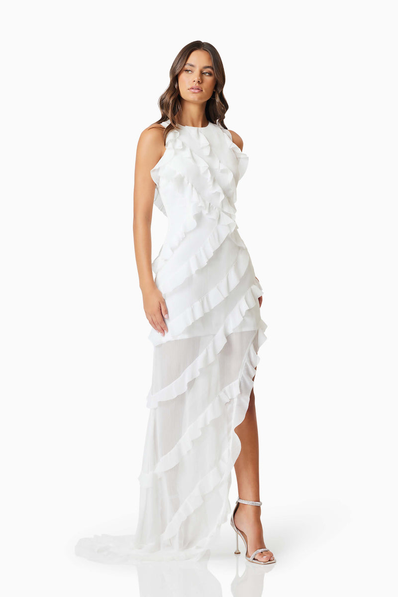 Brunette model wearing Celeana Textured Sheer Dress in White moving shot
