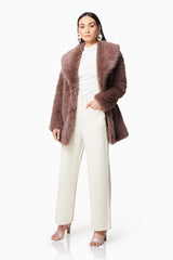 Brunette model wearing WYOMING FAUX FUR COAT IN BROWN front shot