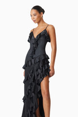 model wearing Kyla Asymmetrical Maxi Dress In Black side shot