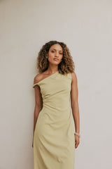 Brunette Model wears CURAAE Elenor Asymmetrical Summer Midi Dress In Olive front shot 