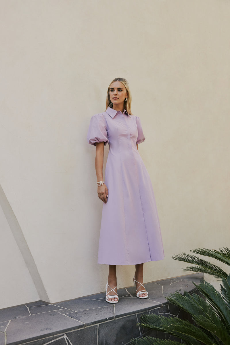 blonde model wears CURAAE Bay Midi Shirt Puff Sleeve A Line Dress In Lilac front shot