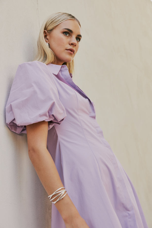 blonde model wears CURAAE Bay Midi Shirt Puff Sleeve A Line Dress In Lilac mood shot