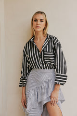 blonde model wears CURAAE Azalea Oversized Contract Stripe Loose Shirt In Black & White mood shot 