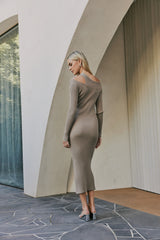 Blonde model wearing CURAAE Amara One Shoulder Asymmetrical Dress Knit Braided Dress In Tan back shot