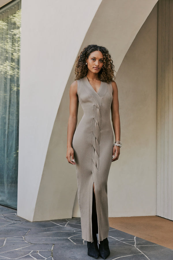 Model wearing CURAAE Zoey Ribbed V Neck Braided Knit Sleeveless Midi Dress In Tan front shot 