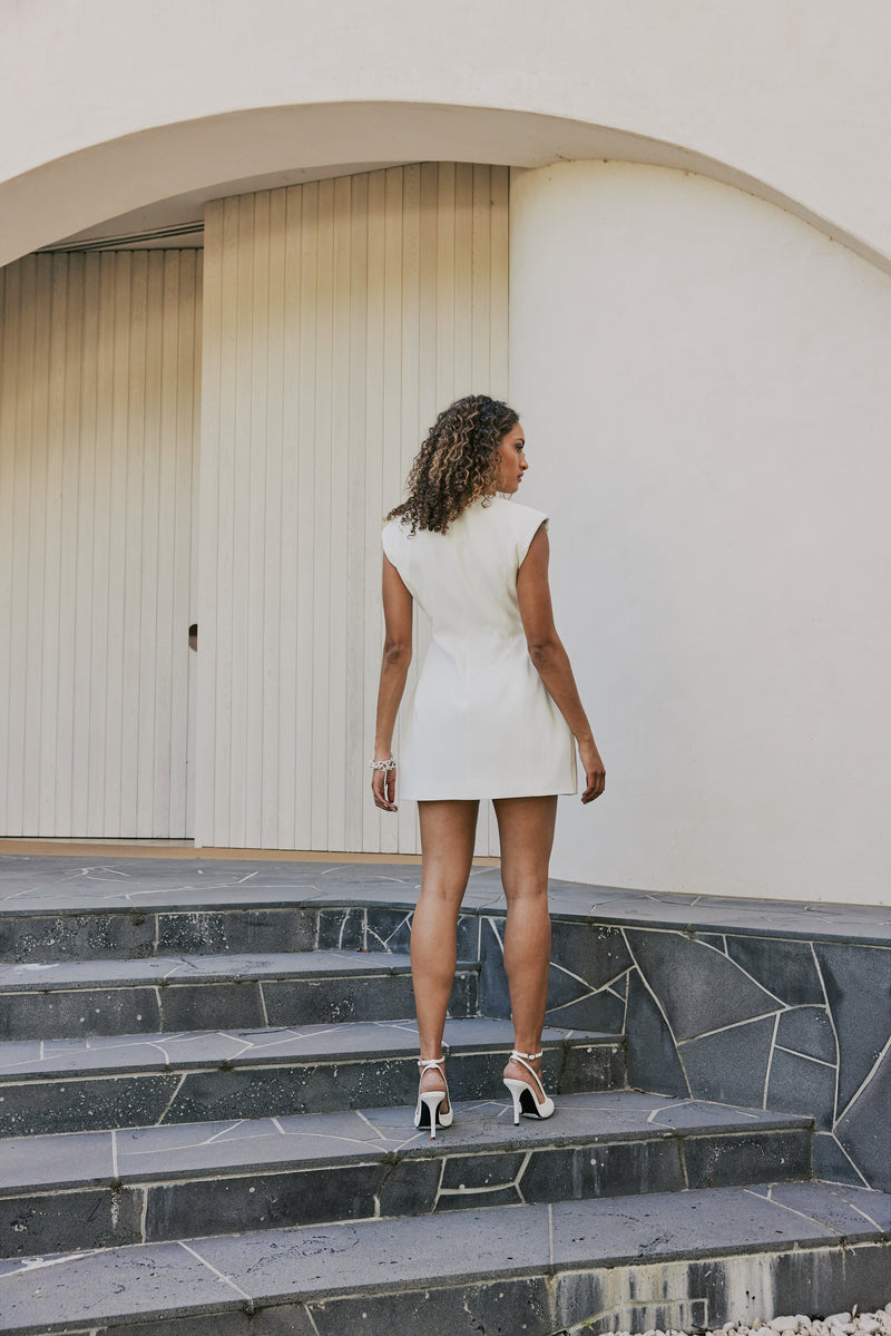 Model wearing Seren Flap Mini Dress In White back shot