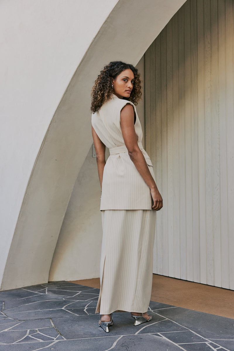 Model wearing Aveline Skirt In Beige back shot