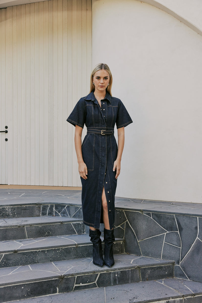 blonde model wears CURAAE Elysia Midi Shirt Belt Denim Dress In Ink front shot