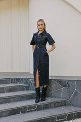 blonde model wears CURAAE Elysia Midi Shirt Belt Denim Dress In Ink side shot