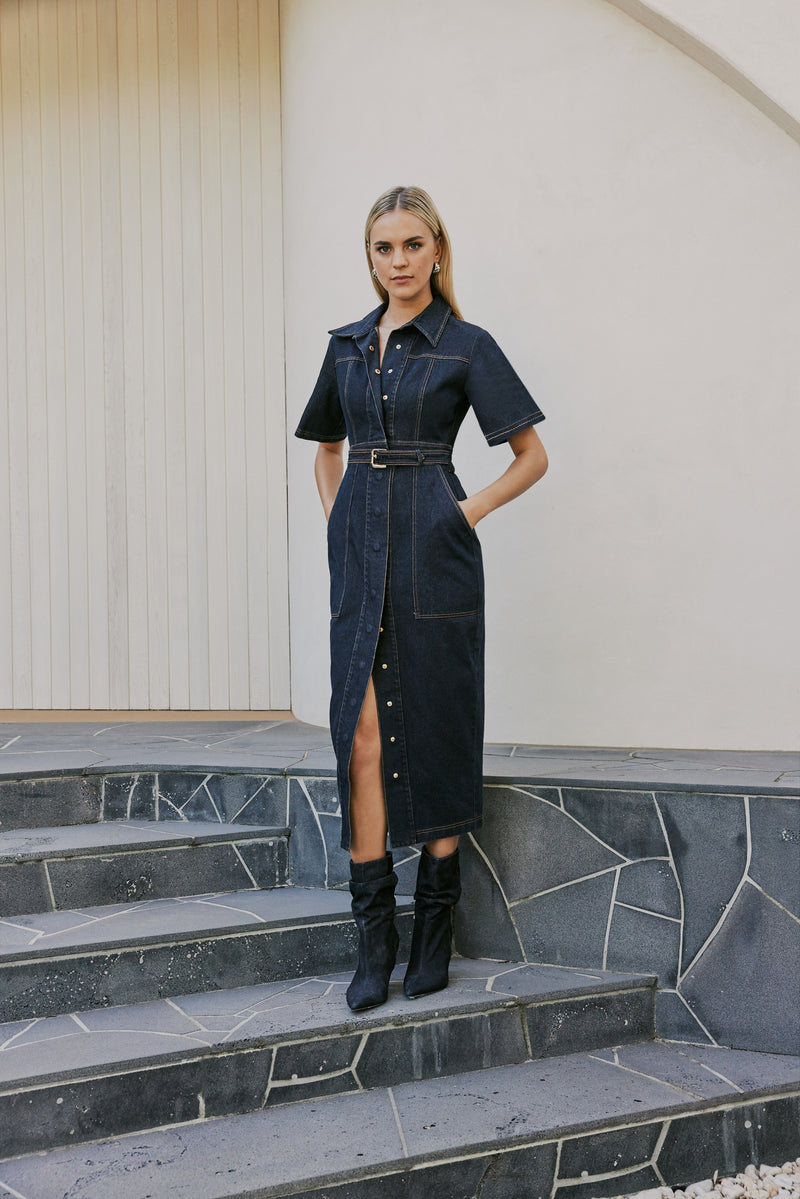 blonde model wears CURAAE Elysia Midi Shirt Belt Denim Dress In Ink side shot 