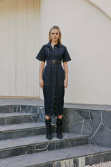 blonde model wears CURAAE Elysia Midi Shirt Belt Denim Dress In Ink front shot 