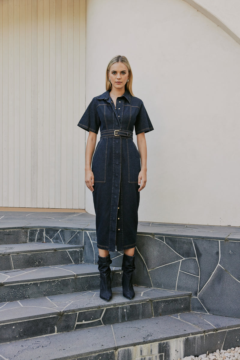 blonde model wears CURAAE Elysia Midi Shirt Belt Denim Dress In Ink front shot