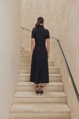 Brunette model wears Oscar Short Sleeve Midi Dress in Black back shot