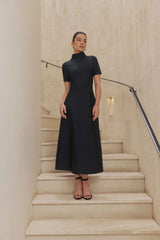 Brunette model wears Oscar Short Sleeve Midi Dress in Black front shot