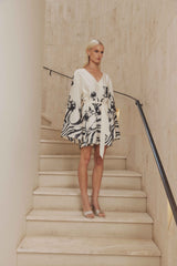 Blonde model wears Saskia V Neck Satin Mini Dress in White front shot