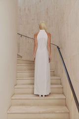 Blonde model wears Chelsea Sleeveless Maxi Dress in White back shot