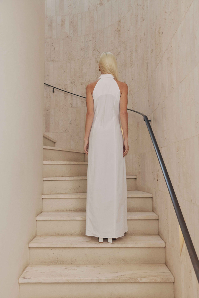 Blonde model wears Chelsea Sleeveless Maxi Dress in White back shot