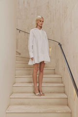 Blonde model wears Eloise Tiered Shirt Dress in White side shot