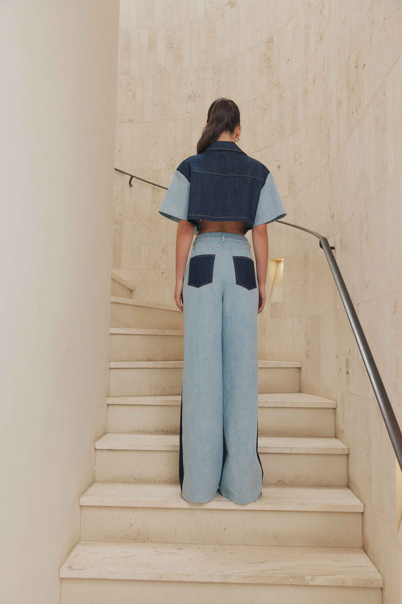 Brunette model wears Lyon Wide Leg Denim Jeans back shot