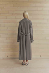 Blonde model wearing London Trench Coat In Brown back shot