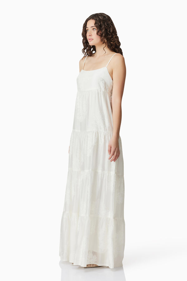 Brunette model wearing Grace Maxi Dress in White side shot