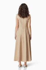 Brunette model wearing Gabriella Midi Dress In Beige back shot