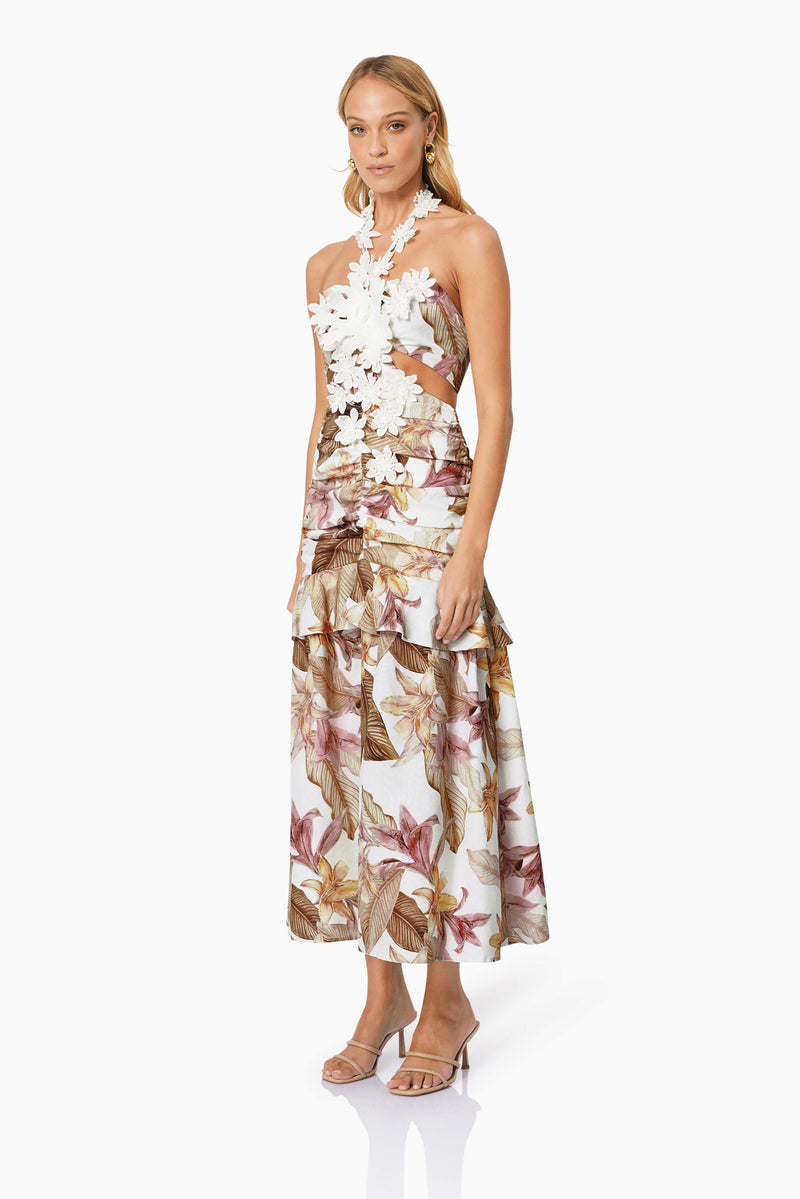 Blonde model wearing MEADOW FLORAL COCKTAIL DRESS IN MULTI side shot