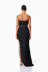 model wearing Megan Strapless Maxi Gown In Black back shot