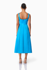 Brunette model wearing Alice Fit and Flare Midi Dress in Blue back shot 