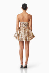 model wearing Alisha Strapless Fit & Flare Mini Dress In Gold back shot