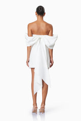 model wearing CALYPSO BOW DETAIL MINI DRESS IN WHITE back shot