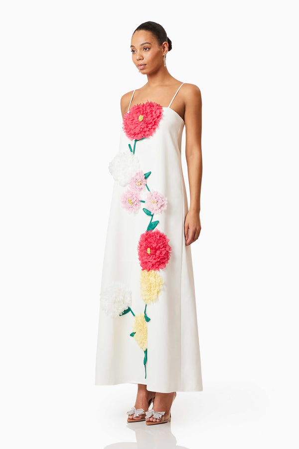 Brunette model wearing Buttercup Embroidered Maxi Dress in White side shot