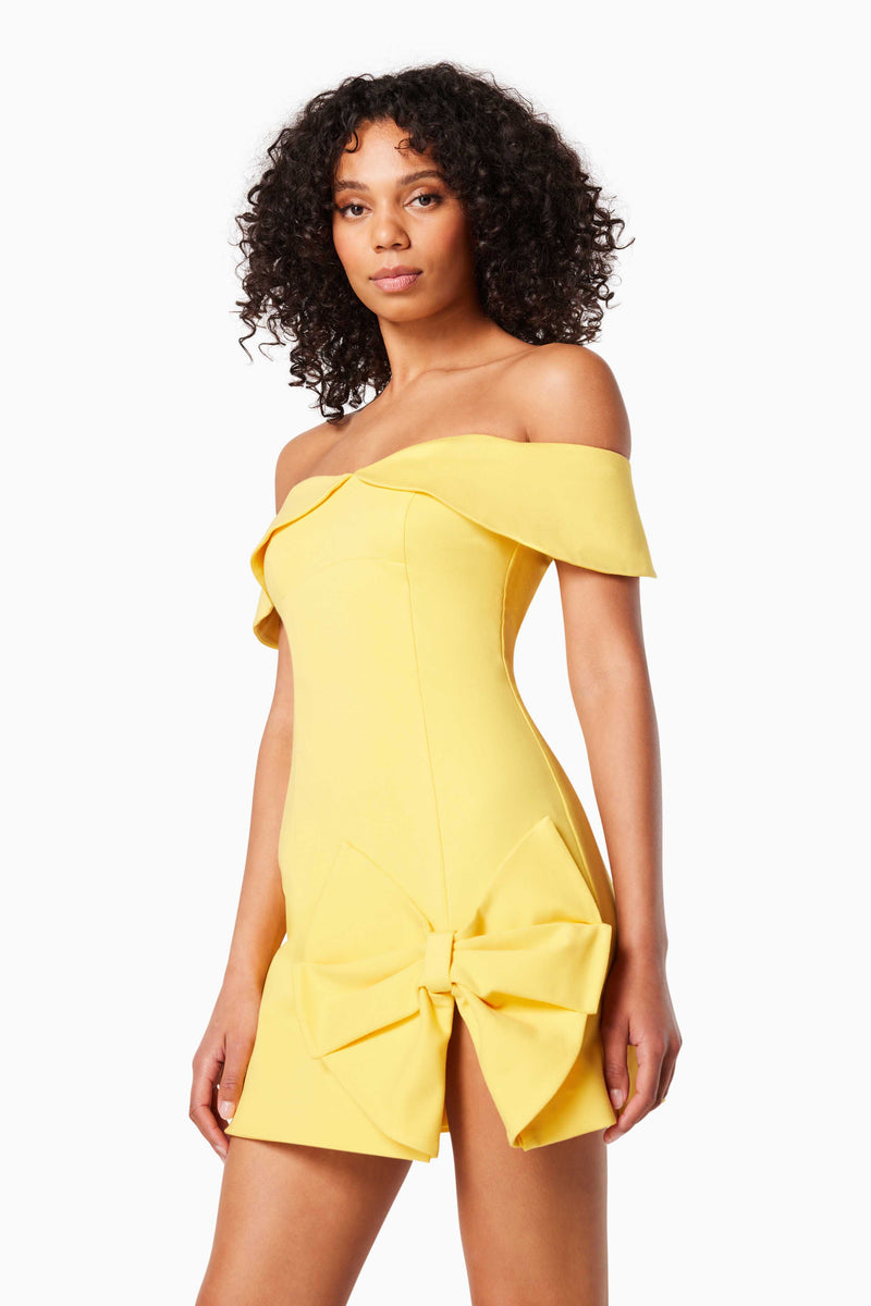model wears CADENCE OFF THE SHOULDER MINI DRESS IN YELLOW close up shot