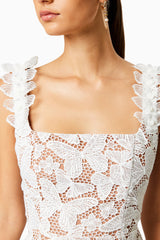 Brunette model wearing PINE LACE MINI DRESS in WHITE close up shot