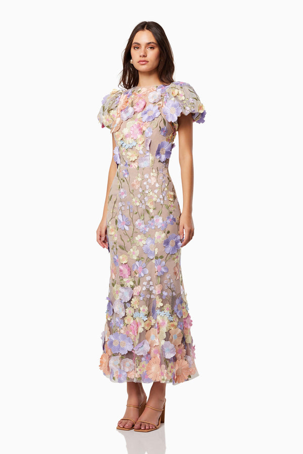 Brunette model is wearing Astraea 3D Lace Maxi Dress in Purple side shot