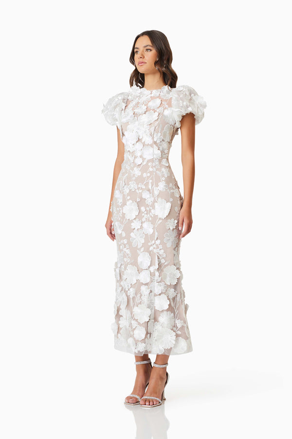 Brunette model wearing Astraea 3D Lace Maxi Dress In White side shot