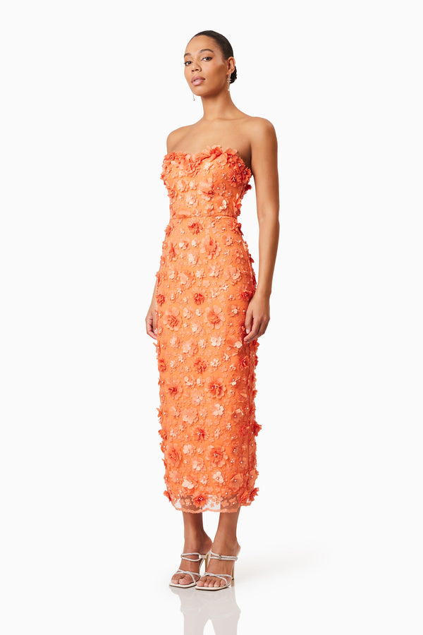 Brunette model wearing Bluebell 3D Midi Dress in Orange side shot