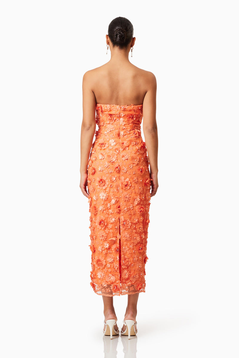 Brunette model wearing Bluebell 3D Midi Dress in Orange back shot