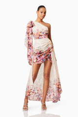 Brunette model wearing Perla Hilo One Shoulder Gown in Floral posed shot