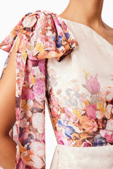 Brunette model wearing Perla Hilo One Shoulder Gown in Floral detail shot