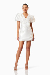 Brunette model wearing Oleander Mini Puff Sleeve Dress In White posed shot