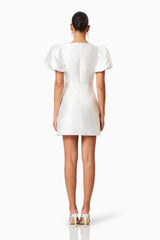 Brunette model wearing Oleander Mini Puff Sleeve Dress In White back shot