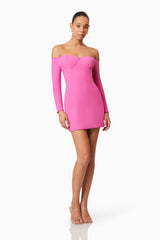 Brunette model wearing Janelle Long Sleeve Mini Dress In Pink posed shot