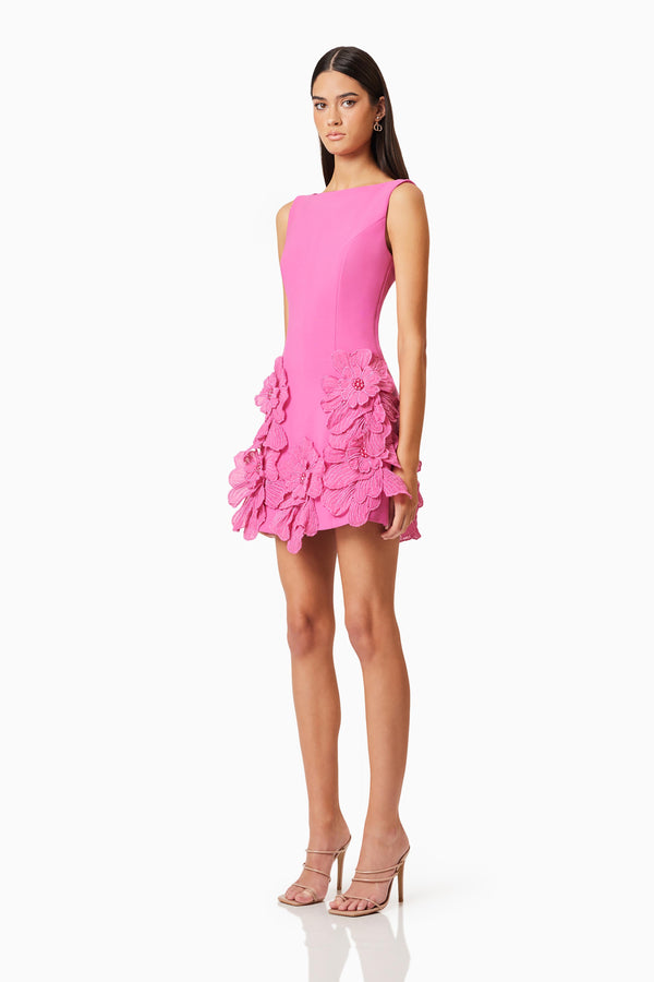 Brunette model wearing Janelle Mini Dress In Pink side shot