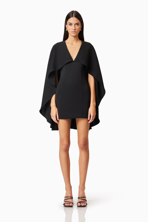 Brunette model wearing Lilydale Cape Mini Dress In Black front shot