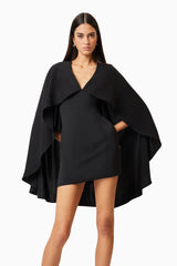 Brunette model wearing Lilydale Cape Mini Dress In Black posed shot